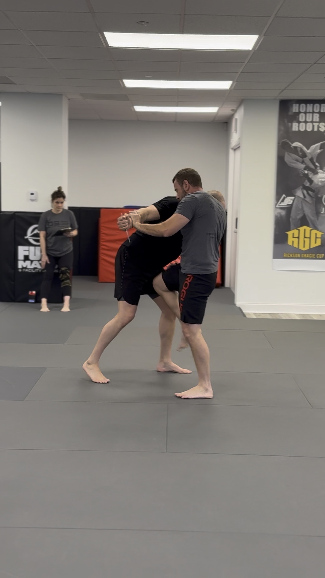 Krav Maga students practicing a controlled close-range defense drill at Pedro Sauer Academy