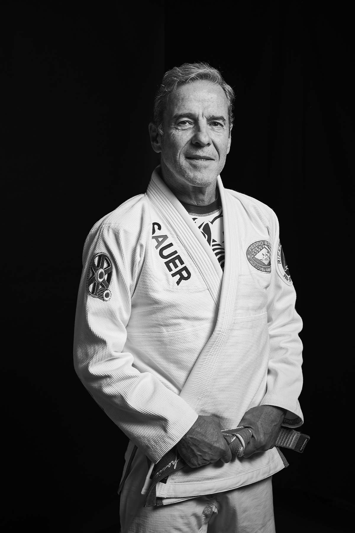Professor Pedro Sauer, 8th-degree Brazilian Jiu-Jitsu coral belt, in a white gi