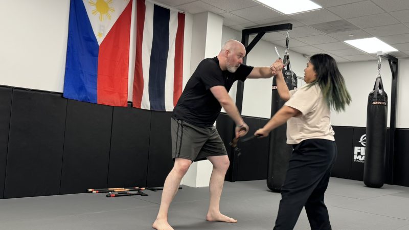 Coach Guy and Coach Kim training Kali techniques at Pedro Sauer Academy in Herndon, VA.